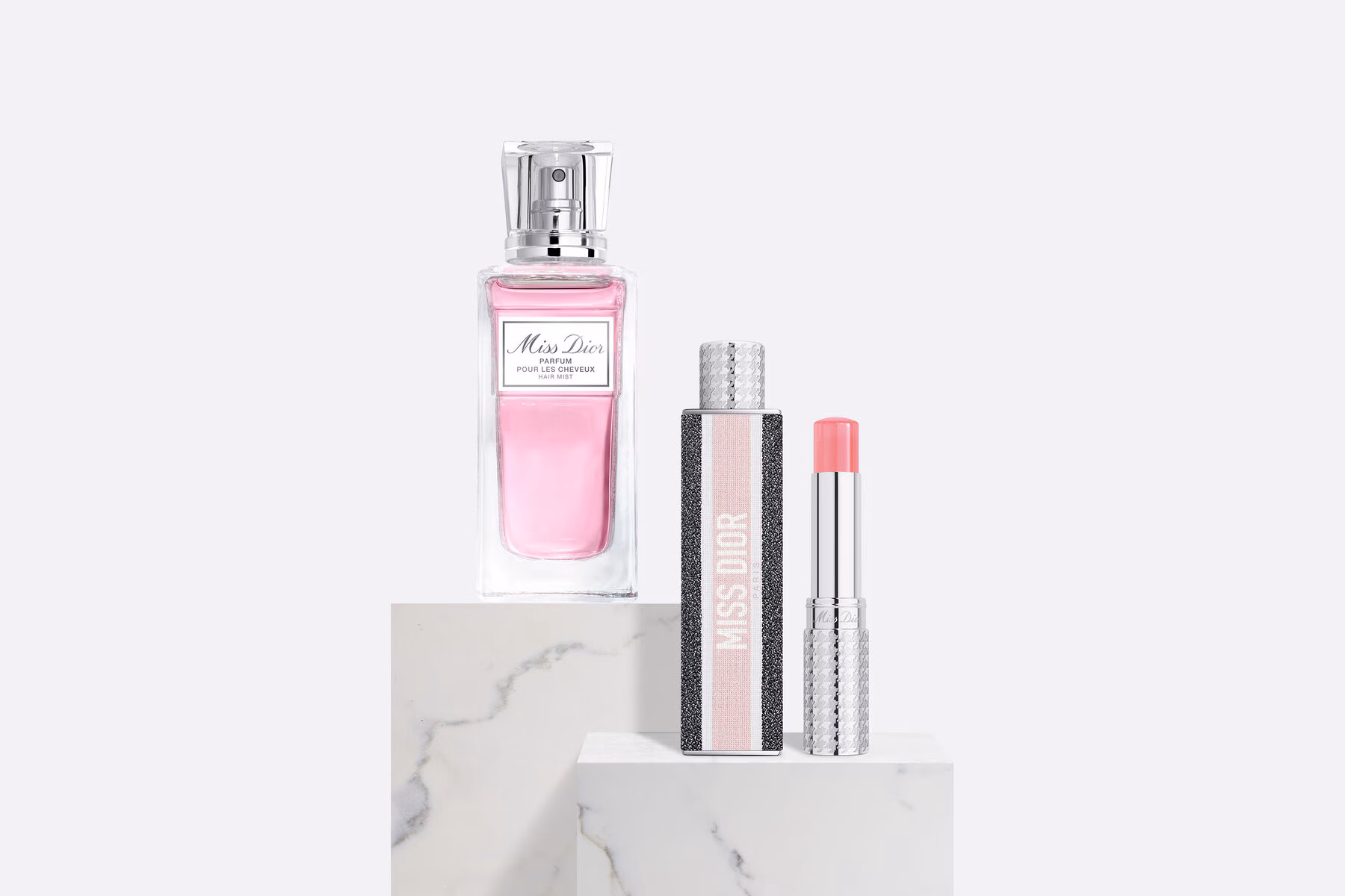 The Dior Miss Dior Gift Set components, including the Miss Dior Eau de Parfum bottle, travel spray, and body milk, elegantly arranged.